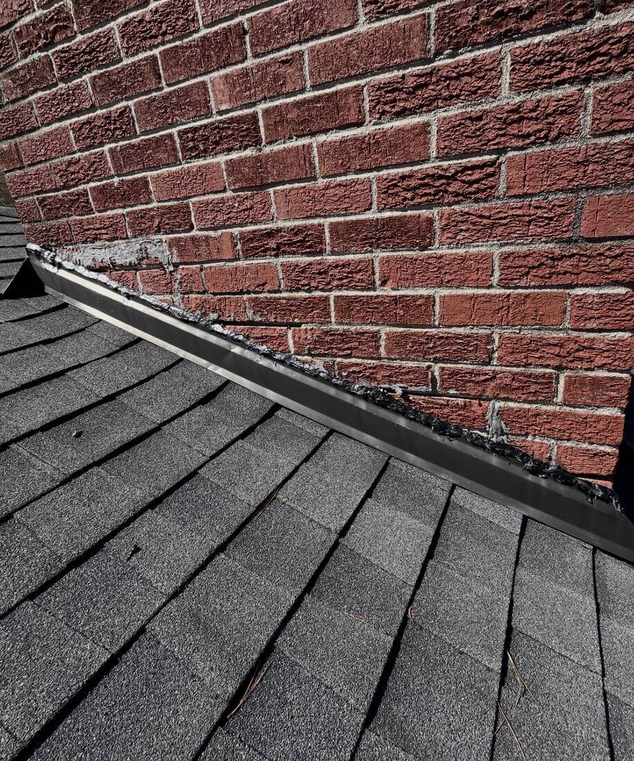 After: Chimney Flashing — Worn, gapped sealant at the chimney base, resealed and cleaned up along the flashing line.