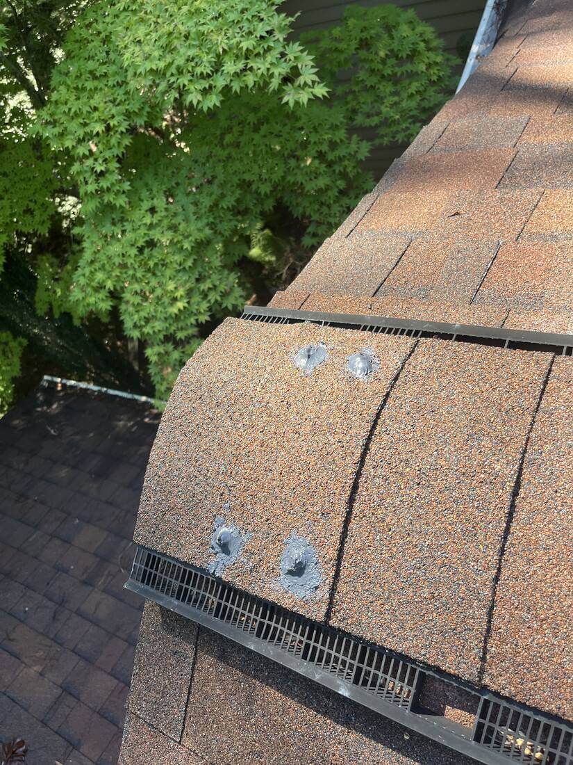 After: Ridge Cap — Fastener heads along the ridge cap resealed to keep water out at the roof's highest seam.