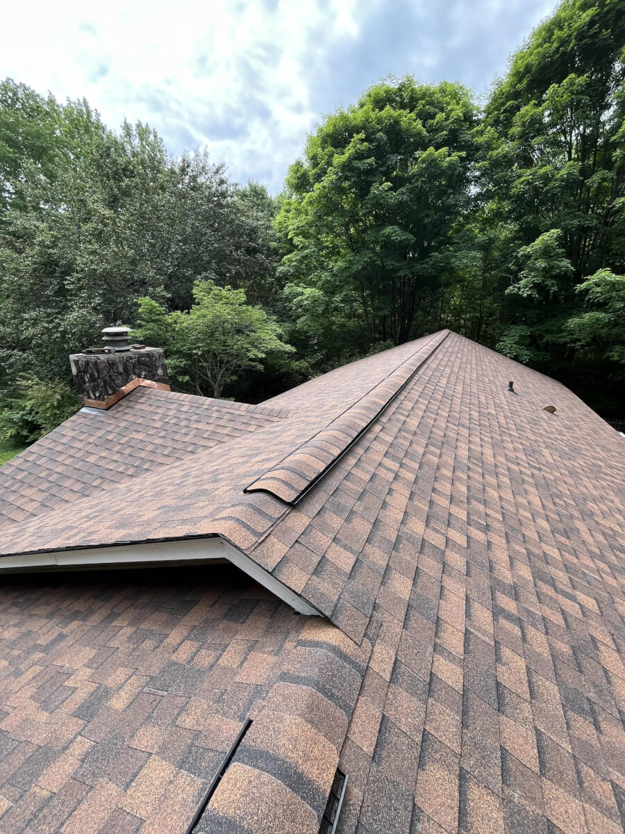 The same Upstate SC home after a full roof replacement, with new shingles and a rebuilt chimney cap